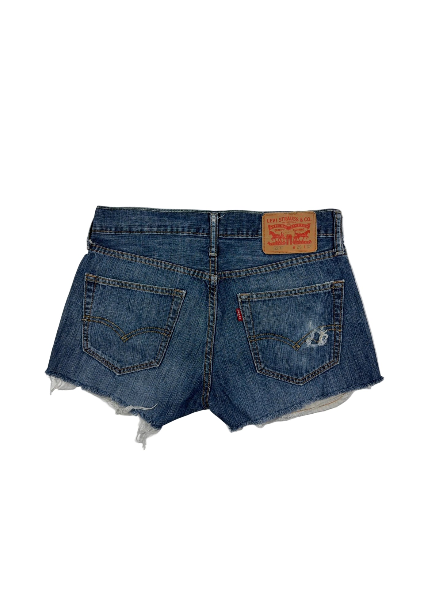 Folded blue denim shorts with brand labels on a white background